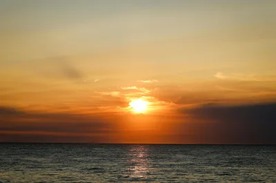 Stunning sunset over Nantucket ocean horizon with vivid orange hues.