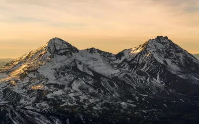 Aerial view of snowcapped Cascade mountains near Bend, Oregon at sunset