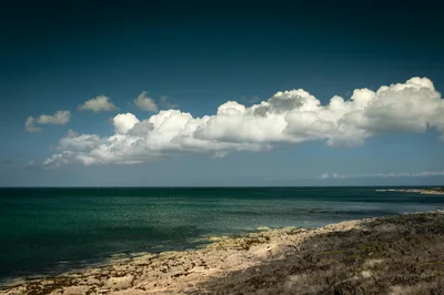 Beautiful seascape of Bangor's rocky coastline under a dramatic cloudy sky.