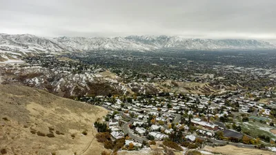 Aerial view of snow-dusted Salt Lake City suburbs looking toward the Wasatch Mountains