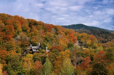 Aerial view of vibrant autumn foliage and rolling hills in the Vermont countryside near Burlington.
