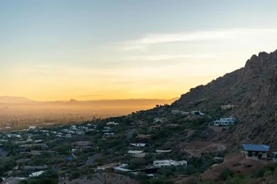 Beautiful landscape view of Phoenix, Arizona during sunset with cityscape and desert hills.