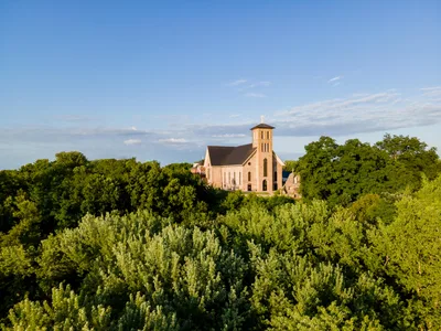 Aerial view of a historic church and lush greenery in Eau Claire, Wisconsin