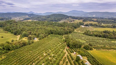Aerial view of the rolling hills and farmland in the North Carolina Piedmont, near the approach to Shelby-Cleveland County Regional Airport.