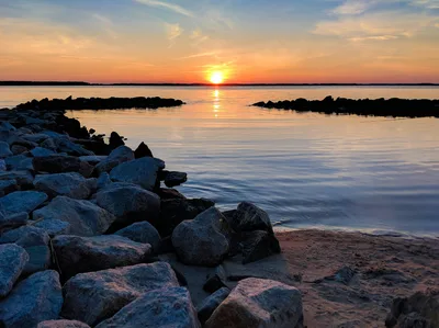 Gorgeous view of a sunset over rocky shorelines in Ocean City, MD, USA.