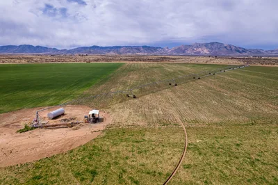 Aerial view of Arizona agricultural fields and desert mountains