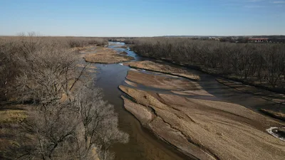 Aerial view of the winding Platte River with sandbanks in a sunlit Nebraska landscape