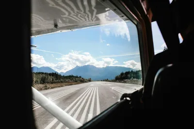 Pilot's point of view of a runway approach in a mountain valley