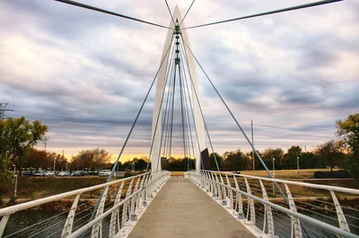 Sunset over the Keeper of the Plains suspension bridge in Wichita, Kansas