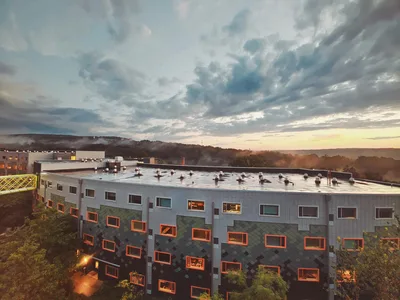 Aerial sunset view of modern architecture and the rolling green landscape in Ithaca, NY.
