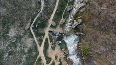 Aerial view of a river winding through the dense pine forest of the Angelina National Forest near Lufkin, Texas.