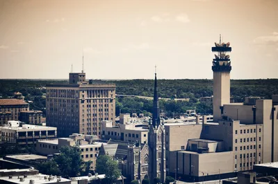 Aerial view of the Little Rock city skyline featuring the Simmons Tower and the Arkansas River area