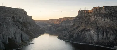 Aerial sunset view of the winding Snake River canyon in Idaho with rugged basalt cliffs