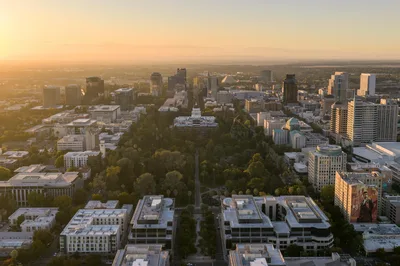 Stunning aerial view of Sacramento's skyline with the California State Capitol at sunset