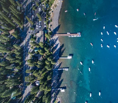 Aerial view of Lake Tahoe shoreline with docks and turquoise water