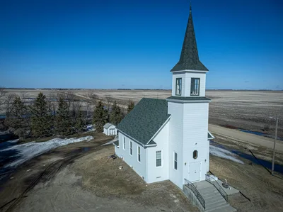 Aerial view of a solitary white church in the vast North Dakota countryside