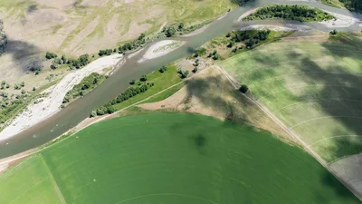 Aerial view of circular irrigated farmland and a river in Eastern Oregon