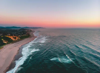 Aerial sunset view of the Oregon coastline and a coastal town