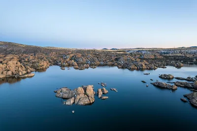 Aerial sunset view of Watson Lake and the unique Granite Dells rock formations in Prescott, Arizona.