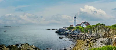 Panoramic aerial-style view of Portland Head Light on Maine's rugged coastline