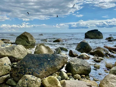 Capture of a rocky shoreline in Plymouth, Massachusetts with dramatic skies and calm ocean.