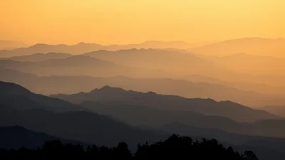 Captivating view of misty mountain layers at sunrise in Taiwan.