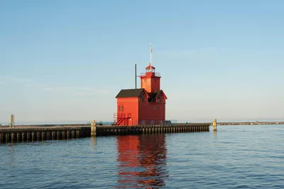 Capture of the vibrant Holland Harbor Lighthouse during a serene summer evening on Lake Michigan.