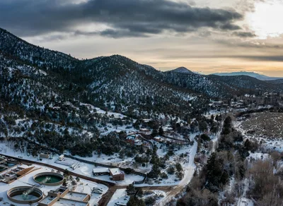 Aerial view of the Santa Fe foothills and mountain valley during winter sunset