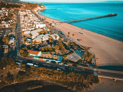 A stunning aerial view of Avila Beach's coastline, pier, and vibrant town near San Luis Obispo.
