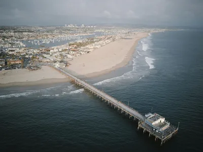 Aerial view of Newport Beach Pier and coastline on the approach to John Wayne Airport