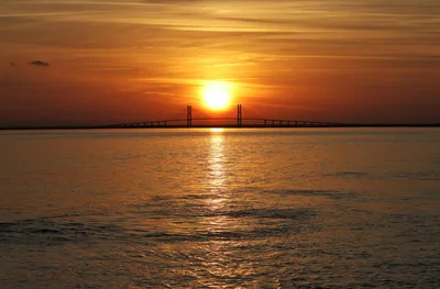 Aerial sunset view of the Sidney Lanier Bridge, the iconic approach landmark for St. Simons Island, Georgia.