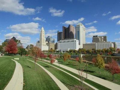 Aerial view of the Columbus, Ohio skyline surrounded by vibrant fall foliage.
