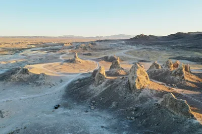 Aerial view of high desert terrain and rock formations at sunrise in the Mojave Desert
