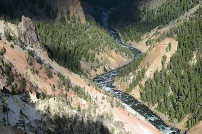 Breathtaking aerial view of the Yellowstone River winding through a lush canyon near West Yellowstone, Montana.