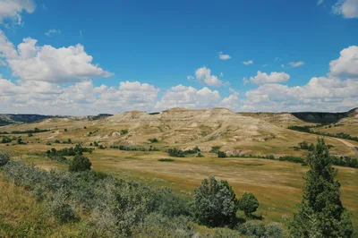 Aerial-style view of the rolling badlands and grassy plains of Theodore Roosevelt National Park in North Dakota