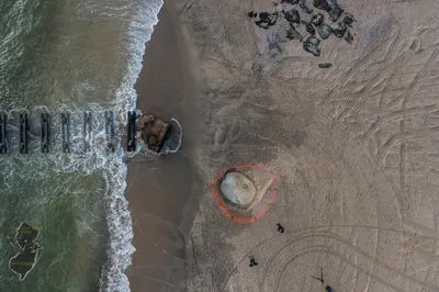 Aerial photograph showing beach structure and waves at Asbury Park, NJ.