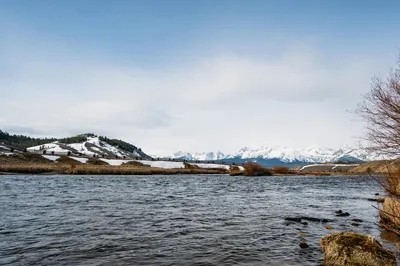Aerial view of a winding river through the snowy mountains of the Idaho backcountry.
